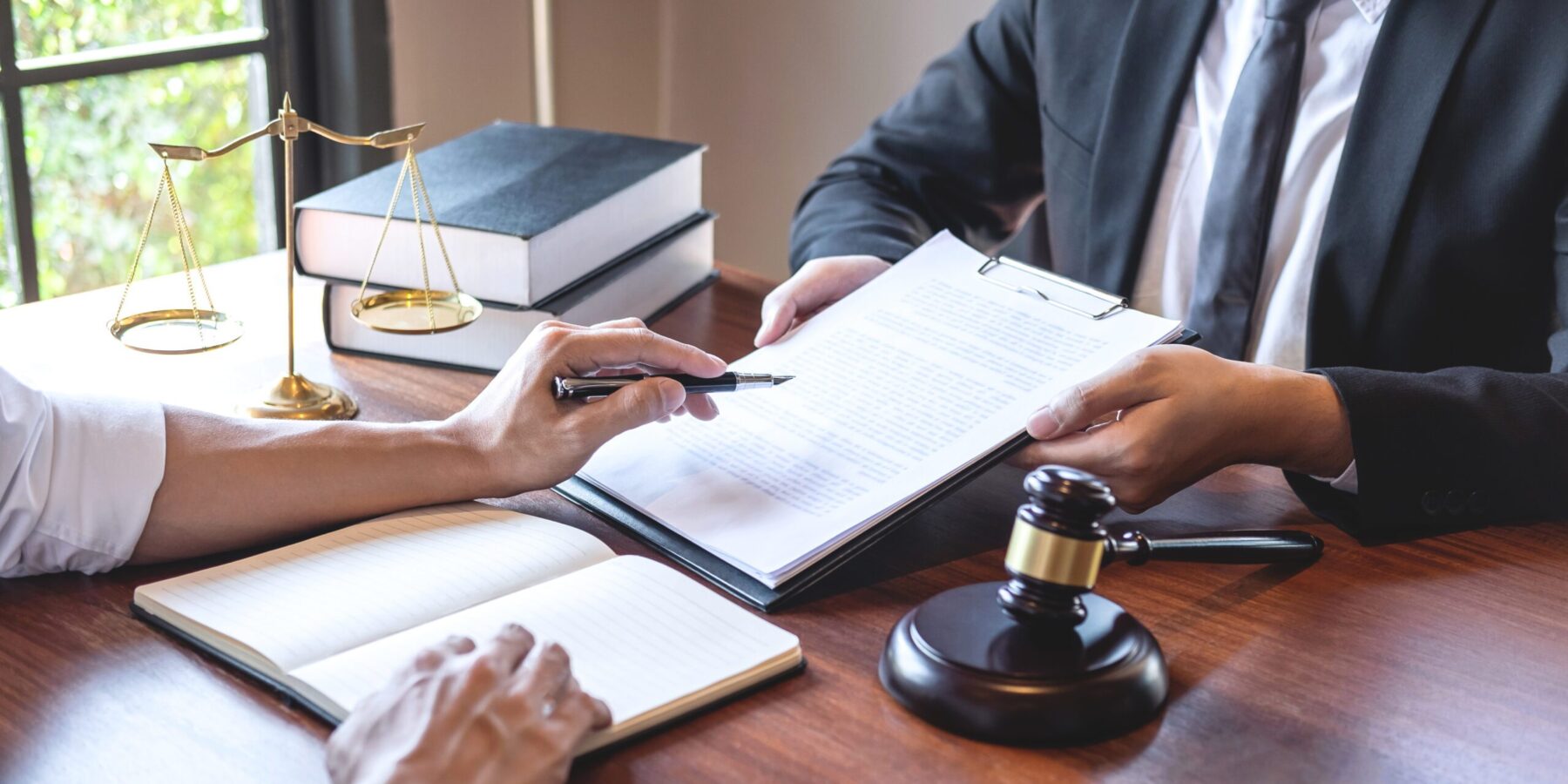Male lawyer discussing negotiation legal case with client meeting with document contact in courtroom, law and justice concept.