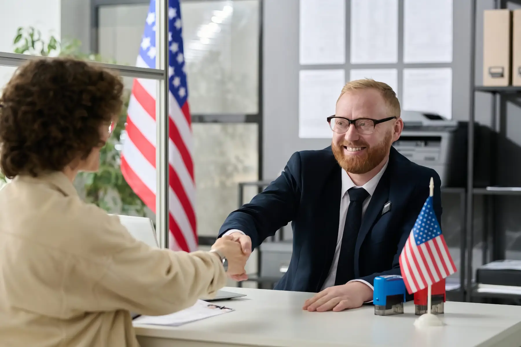 immigration lawyer shakes hand with a client
